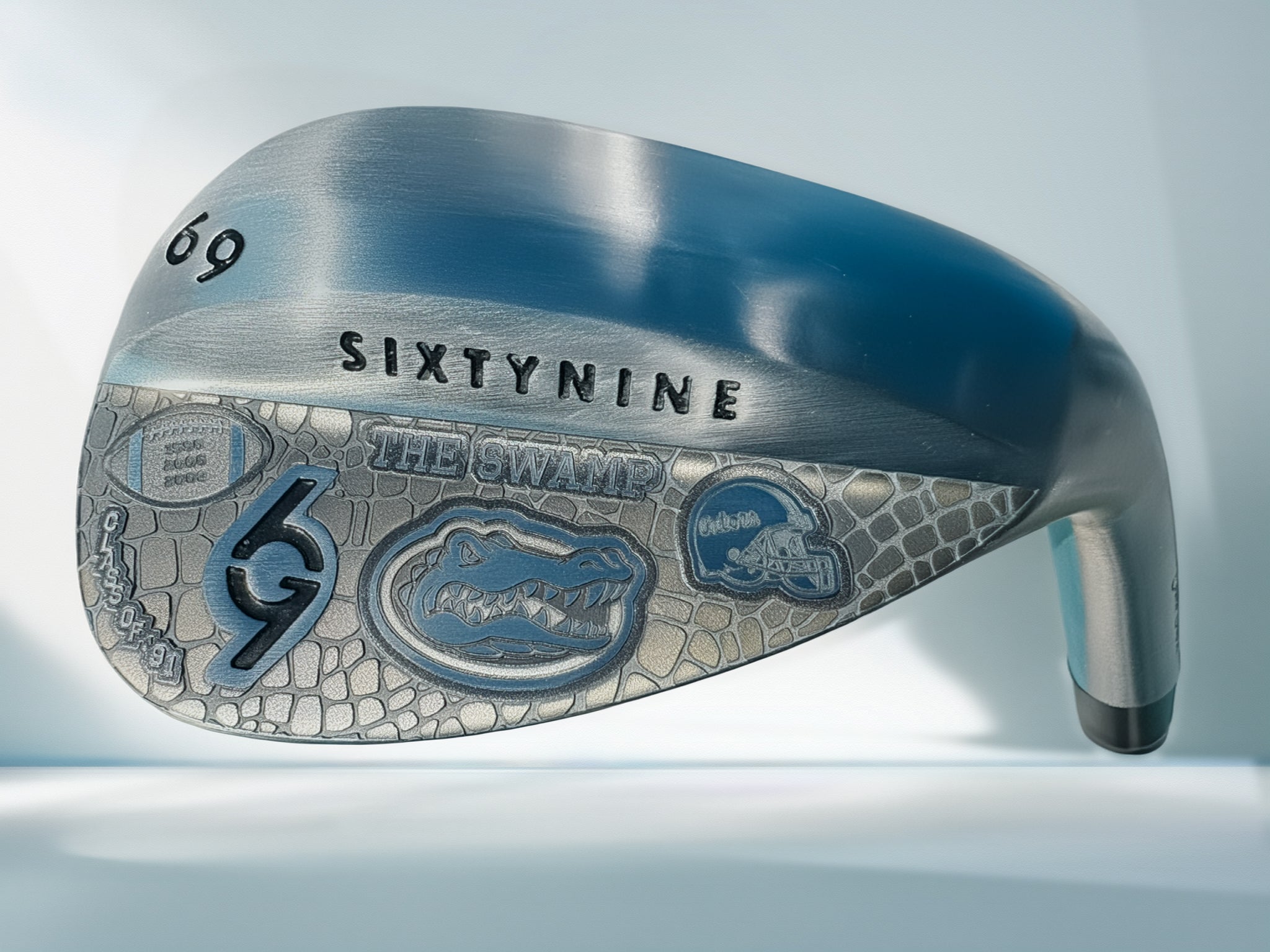 Golf club head with 'SixtyNine' branding , custom engraved with flordia gators, on a light gray background