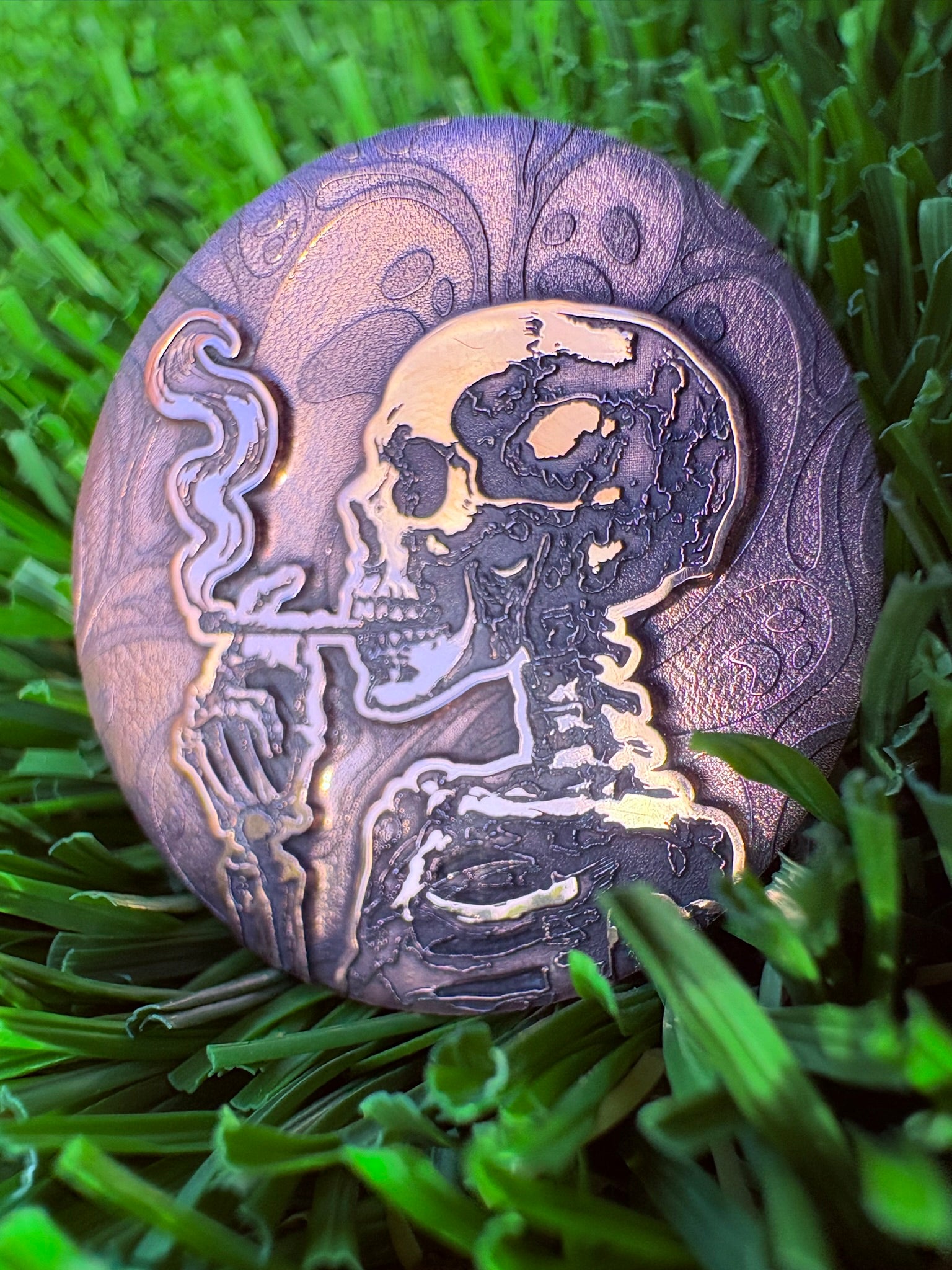 Decorative stone with a skeleton design on grass