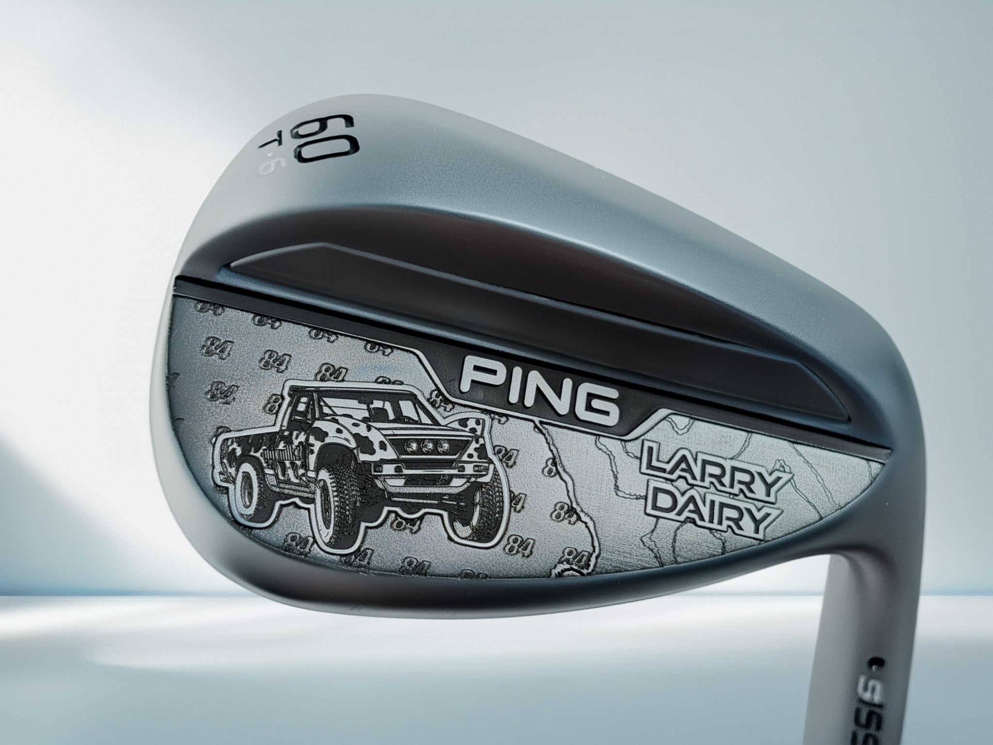 Golf club head with 'Ping' and 'Larry Dairy' branding on a light gray background