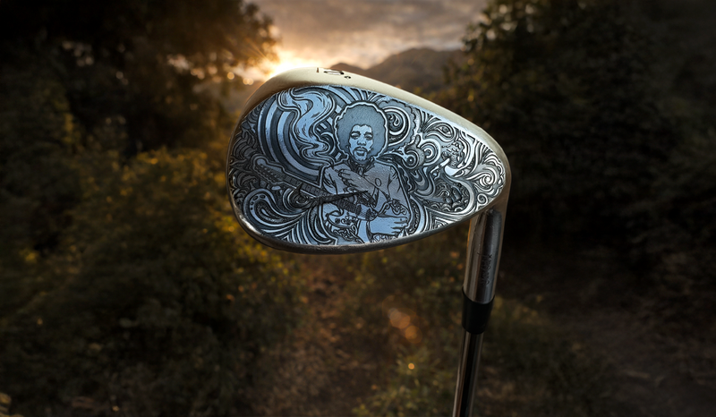 Golf club head with intricate design against a blurred natural background