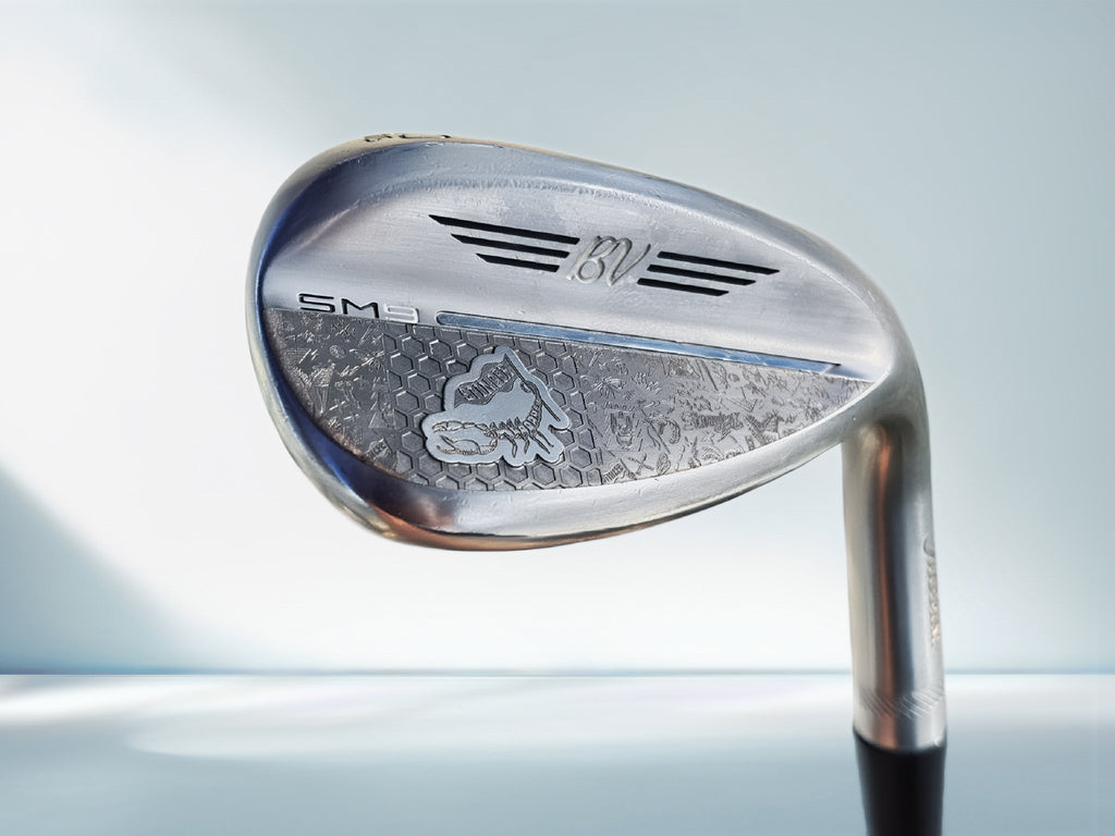 Golf club head with brand logo on a light blue background